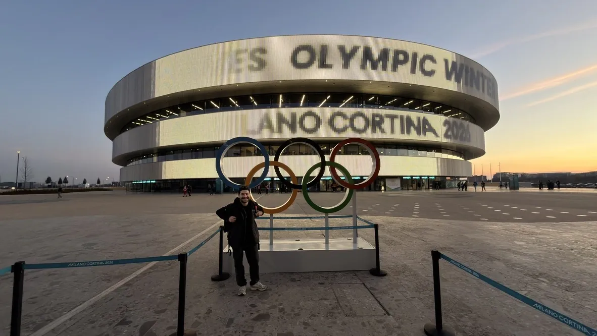 Juan Morales posing with the Olympic rings at the Milano Cortina 2026 Winter Games