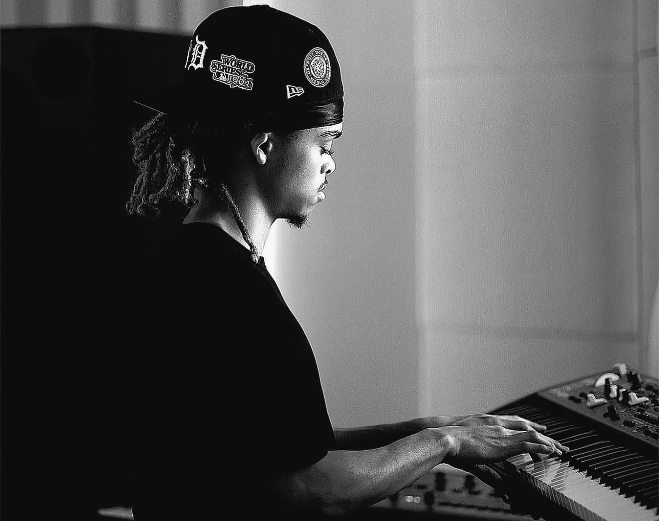 Raymond Herring playing a keyboard in his home studio