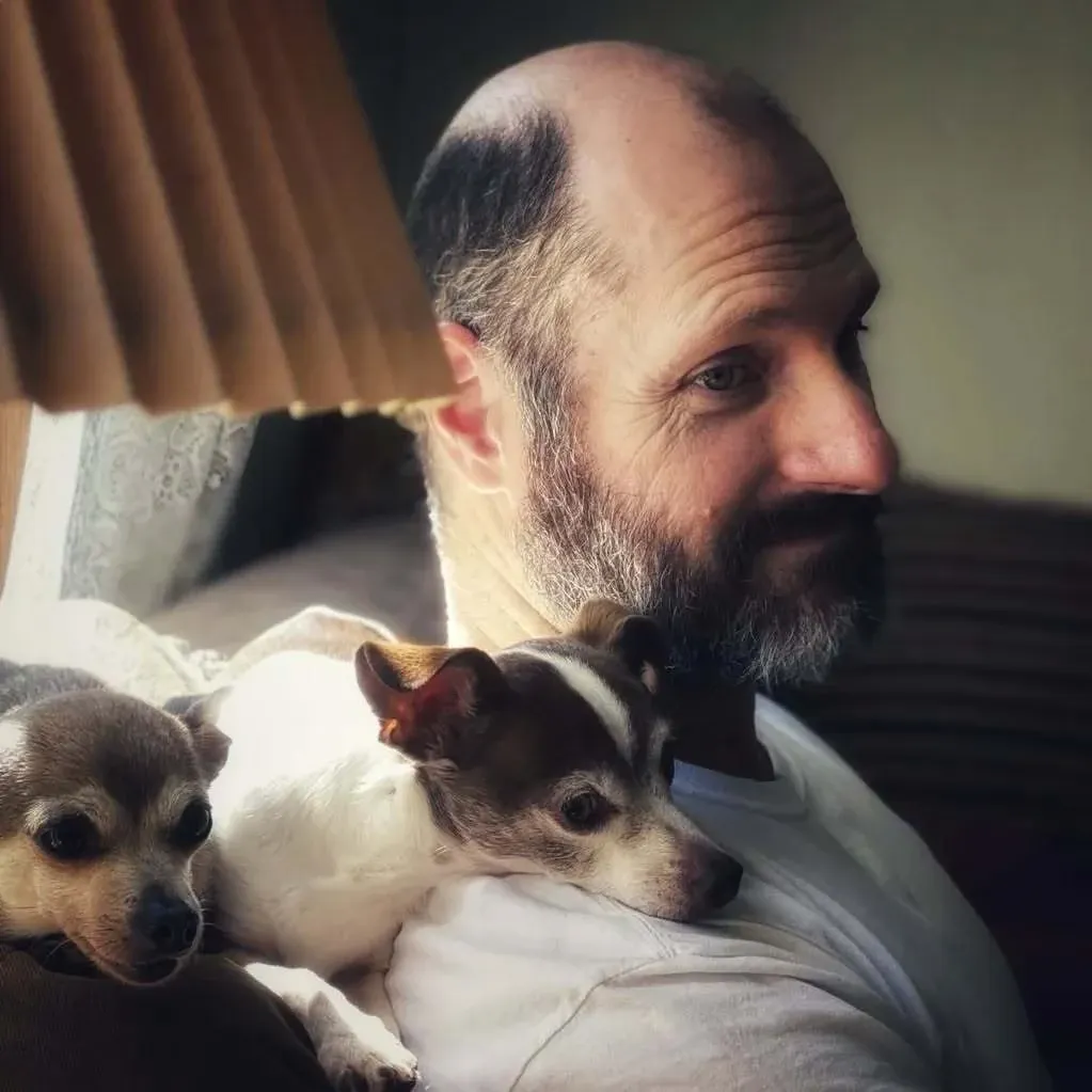 Trevor J. Wilson sitting with his two dogs